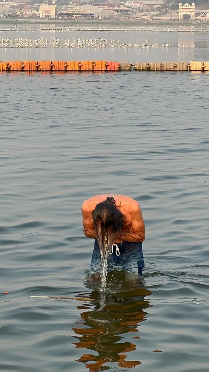 A pilgrim bathing at the Maha Kumbh Mela in Prayagraj